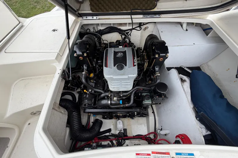 Slide: The Image of Engine compartment of a 2009 Sea Ray 210 Sundeck boat, showcasing the motor and components. - 25