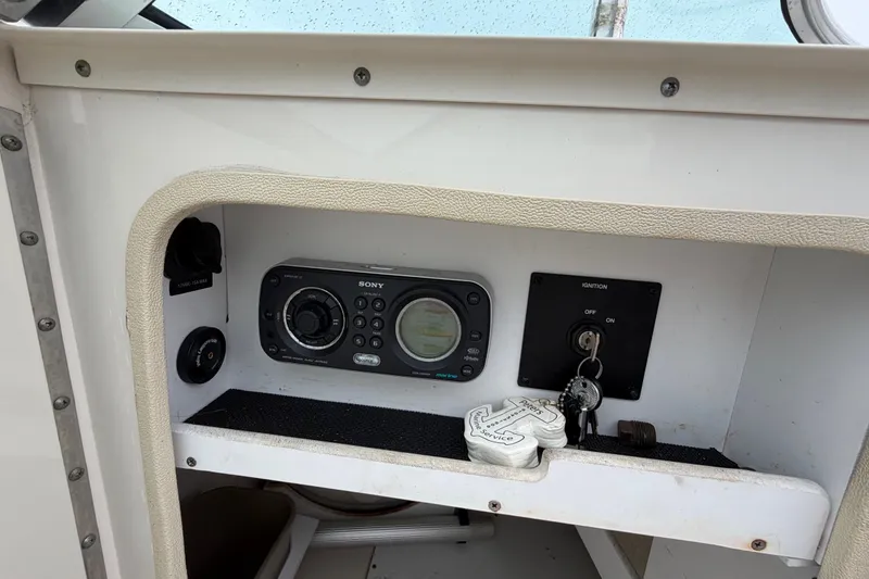 Slide: The Image of Control panel of a 2009 Sea Ray 210 Sundeck with Sony stereo and ignition keys. - 26