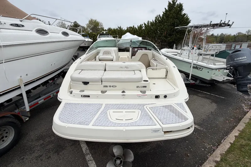 Slide: The Image of 2009 Sea Ray 210 Sundeck boat in a marina, surrounded by other boats. - 5