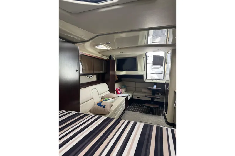 Slide: The Image of Interior of 2013 Monterey 340 Sport Yacht with modern seating and striped bedding. - 18
