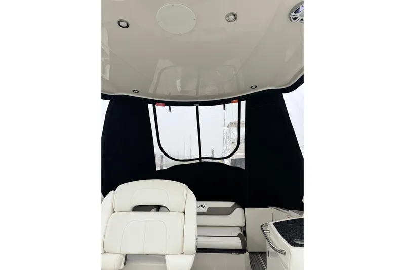 Slide: The Image of Interior view of a 2013 Monterey 340 Sport Yacht with white seating and black canopy. - 19