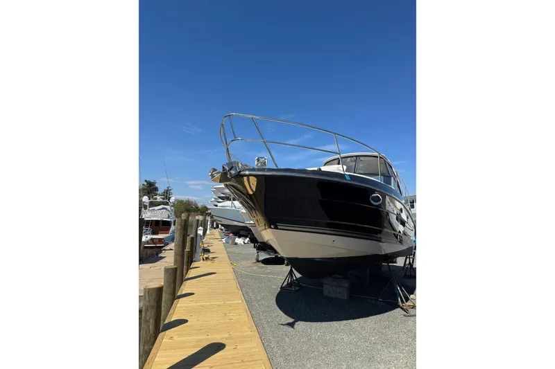 Slide: The Image of 2013 Monterey 340 Sport Yacht docked under clear blue sky. - 2