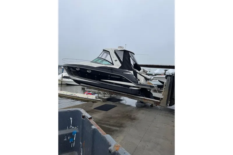 Slide: The Image of 2013 Monterey 340 Sport Yacht on a lift at a marina dock. - 3