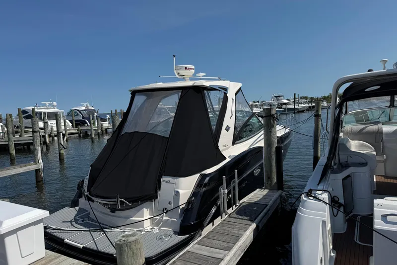 Slide: The Image of 2013 Monterey 340 Sport Yacht docked at marina under clear blue sky. - 4