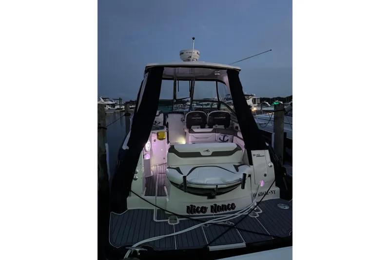 Slide: The Image of 2013 Monterey 340 Sport Yacht docked at night with illuminated interior. - 5