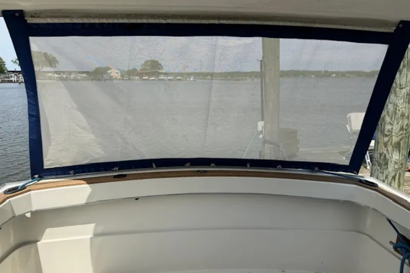 Slide: The Image of 1978 Mainship 34 Trawler cockpit view with water and dock in background. - 12