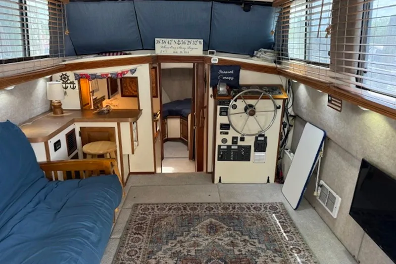 Slide: The Image of Interior of a 1978 Mainship 34 Trawler with cozy seating and nautical decor. - 14