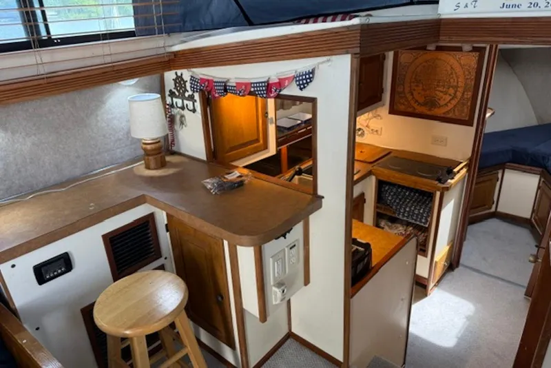 Slide: The Image of Interior of a 1978 Mainship 34 Trawler featuring a cozy kitchen and seating area. - 15