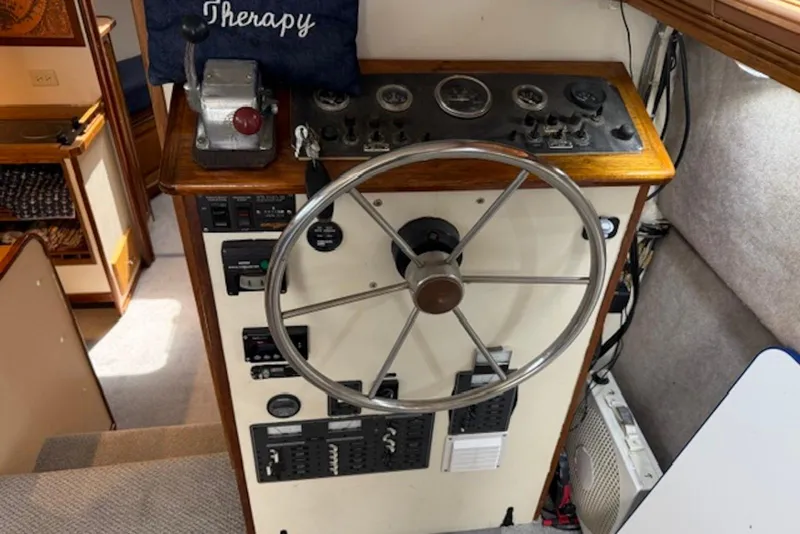 Slide: The Image of 1978 Mainship 34 Trawler helm with steering wheel and control panel. - 18
