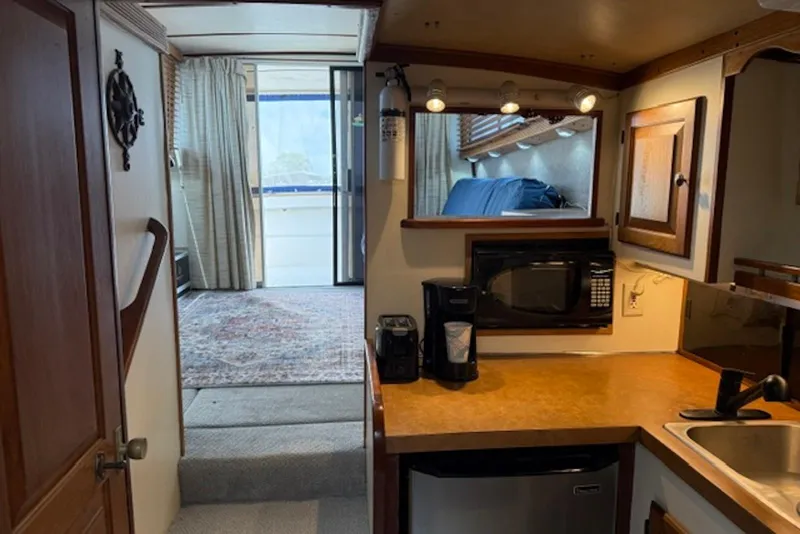 Slide: The Image of Interior of a 1978 Mainship 34 Trawler with kitchenette and cozy living space. - 19
