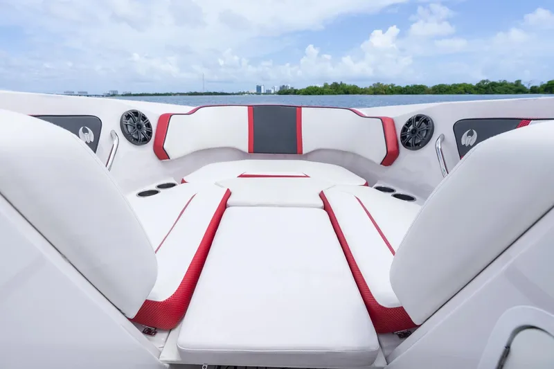 Slide: The Image of 2017 Scarab 255 H.O. Impulse boat interior with white and red seating, speakers, and cup holders. - 16