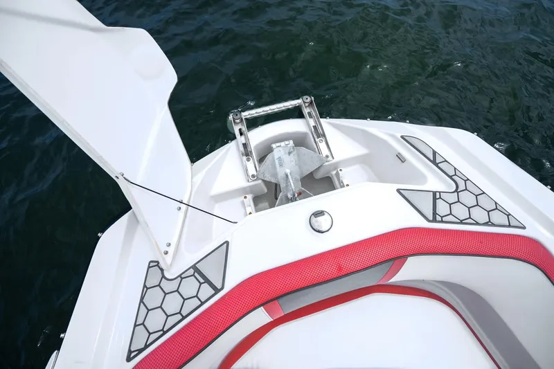 Slide: The Image of 2017 Scarab 255 H.O. Impulse boat bow with anchor storage, red trim, and hexagonal design. - 17