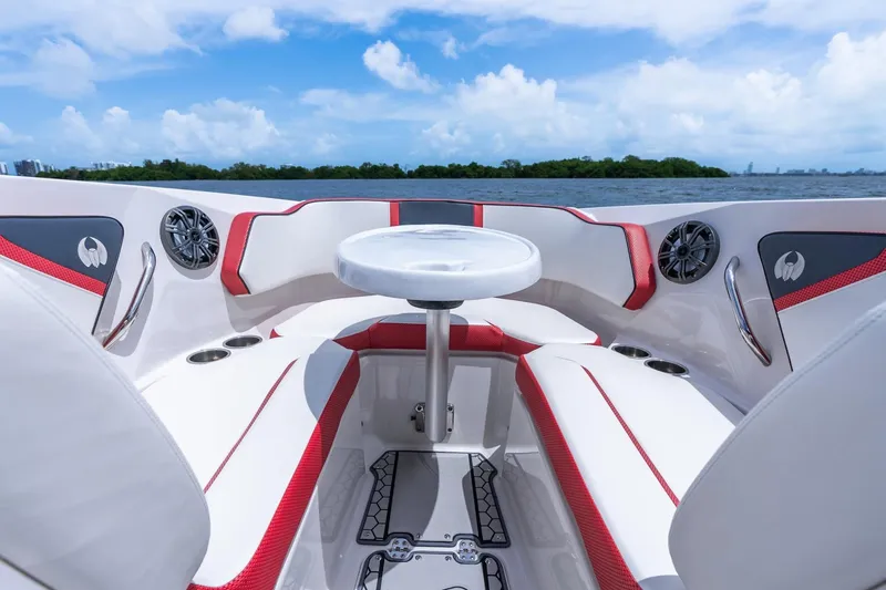 Slide: The Image of 2017 Scarab 255 H.O. Impulse boat interior with red accents and seating, on a sunny day. - 18