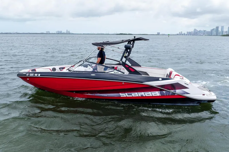 Slide: The Image of 2017 Scarab 255 H.O. Impulse boat cruising on open water, side view. - 28