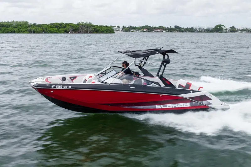 Slide: The Image of 2017 Scarab 255 H.O. Impulse speedboat cruising on open water. - 29