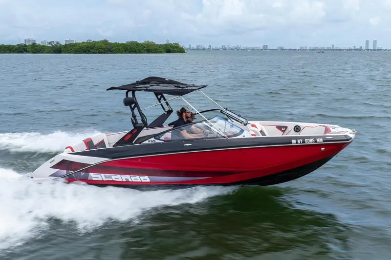 Slide: The Image of 2017 Scarab 255 H.O. Impulse speedboat cruising on open water, showcasing sleek red design. - 30