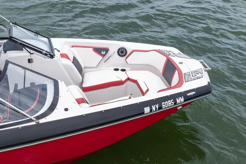 Slide: The Image of 2017 Scarab 255 H.O. Impulse boat with red and white seating on water. - 31