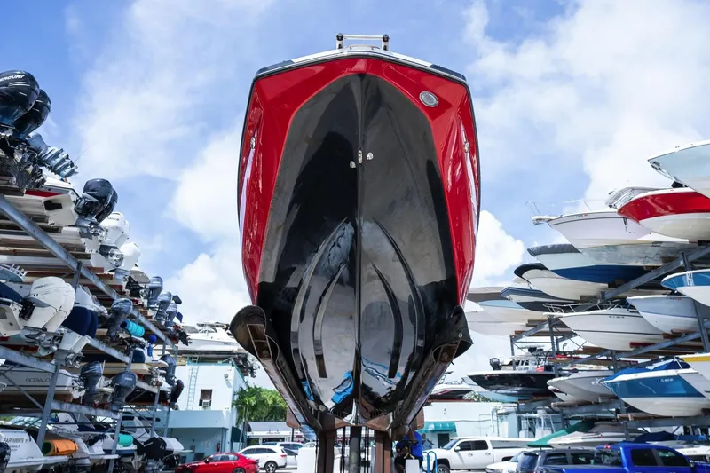 Slide: The Image of Red and black 2017 Scarab 255 H.O. Impulse boat stored in a marina. - 6