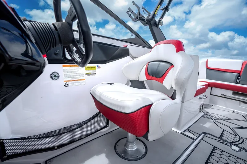 Slide: The Image of 2017 Scarab 255 H.O. Impulse boat interior with red and white seating, steering wheel, and sky view. - 9