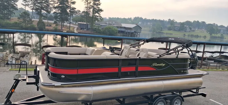 Slide: The Image of 2026 Bentley Pontoons Legacy 220 Navigator on trailer by the lake. - 4