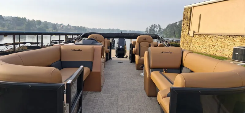 Slide: The Image of Luxurious Bentley Pontoons Legacy 240 Navigator 2026 on a serene lake. - 2