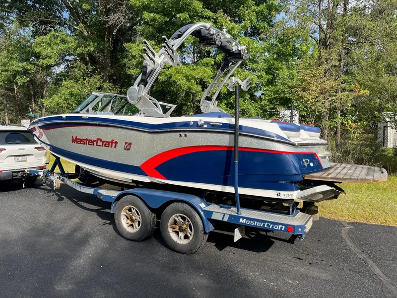Slide: The Image of 2015 MasterCraft X20 boat parked on trailer outdoors. - 10
