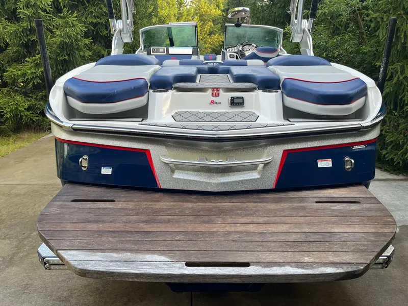 Slide: The Image of Rear view of a 2015 MasterCraft X20 boat on a dock. - 12