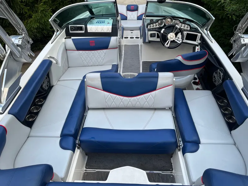 Slide: The Image of Interior of a 2015 MasterCraft X20 boat with blue and white seating. - 23