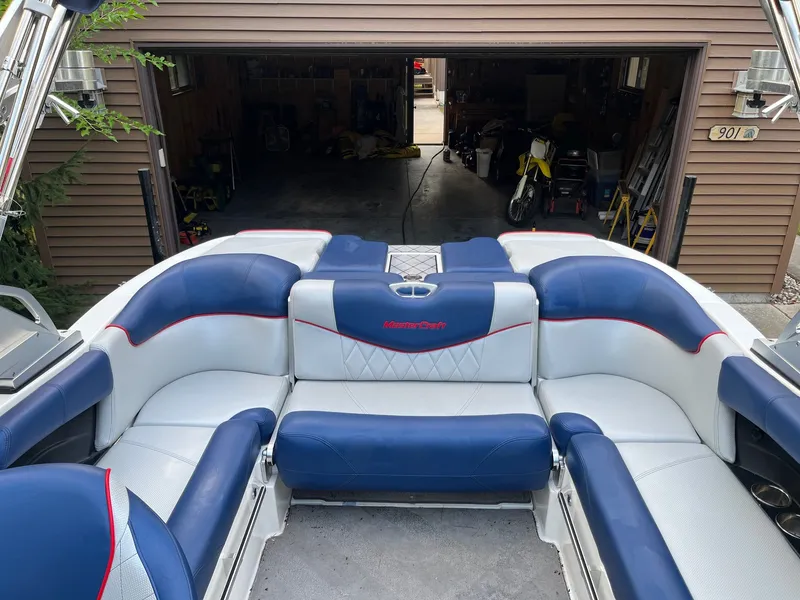 Slide: The Image of 2015 MasterCraft X20 boat with blue and white seating. - 24