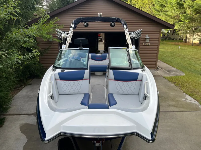 Slide: The Image of 2015 MasterCraft X20 boat parked in front of a garage. - 3