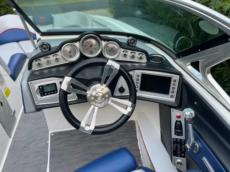 Slide: The Image of Dashboard of a 2015 MasterCraft X20 boat with steering wheel and gauges. - 30
