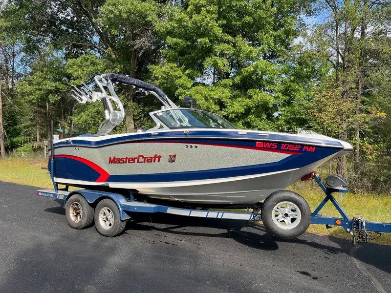 Slide: The Image of 2015 MasterCraft X20 boat on trailer outdoors. - 5