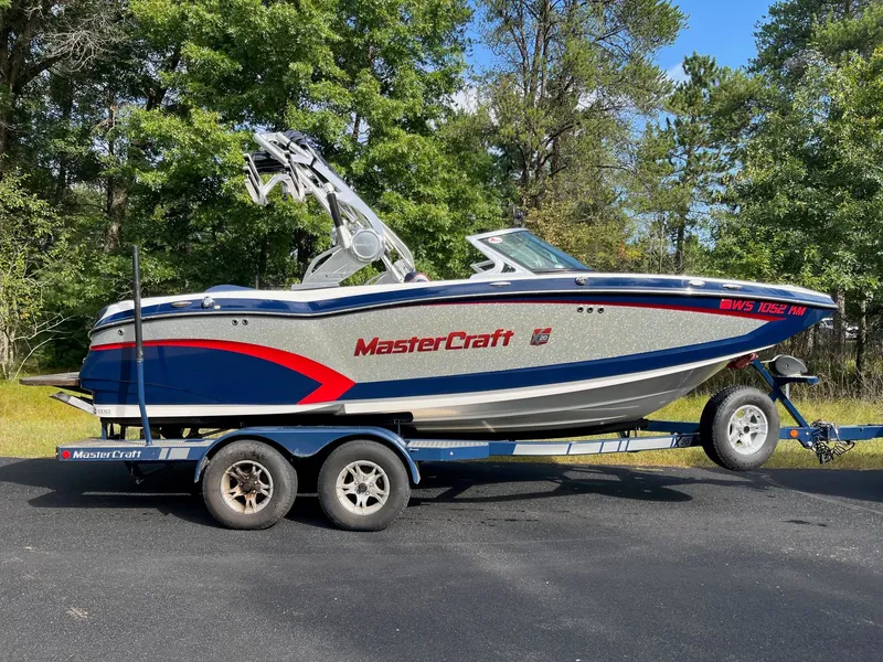 Slide: The Image of 2015 MasterCraft X20 boat on trailer outdoors. - 6
