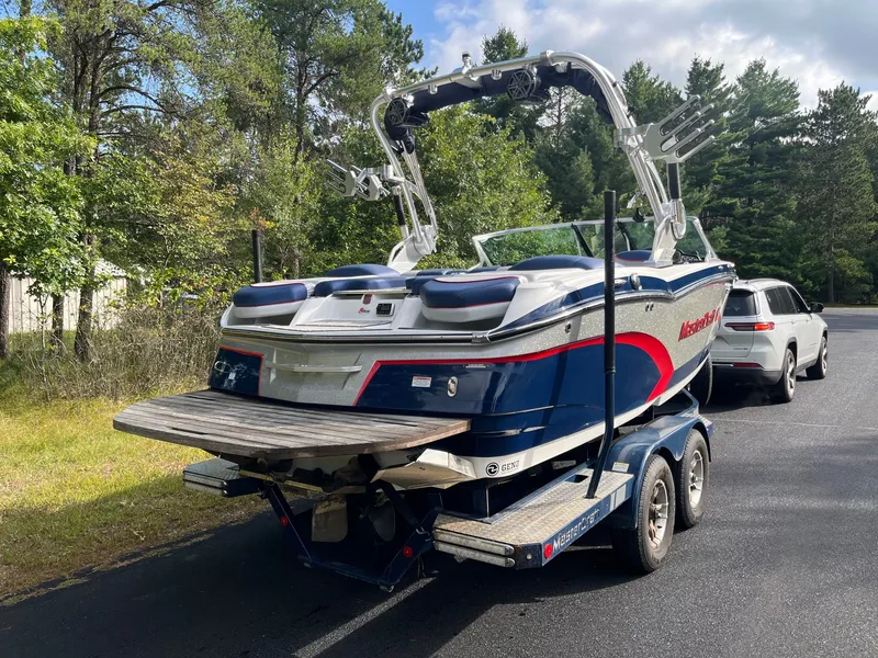 Slide: The Image of 2015 MasterCraft X20 boat on trailer parked outdoors. - 8