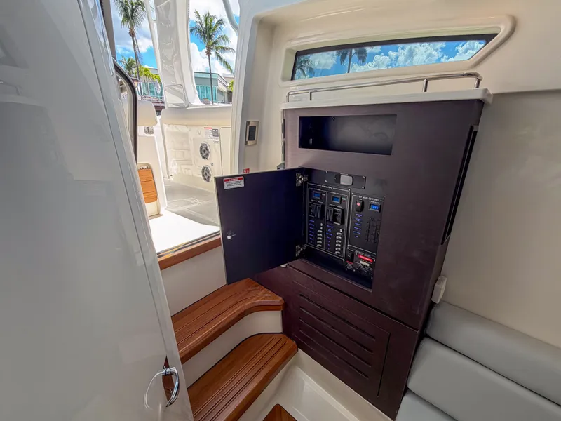 Slide: The Image of The image shows the interior of a 2027 Boston Whaler 350 Realm with an electrical panel. - 38