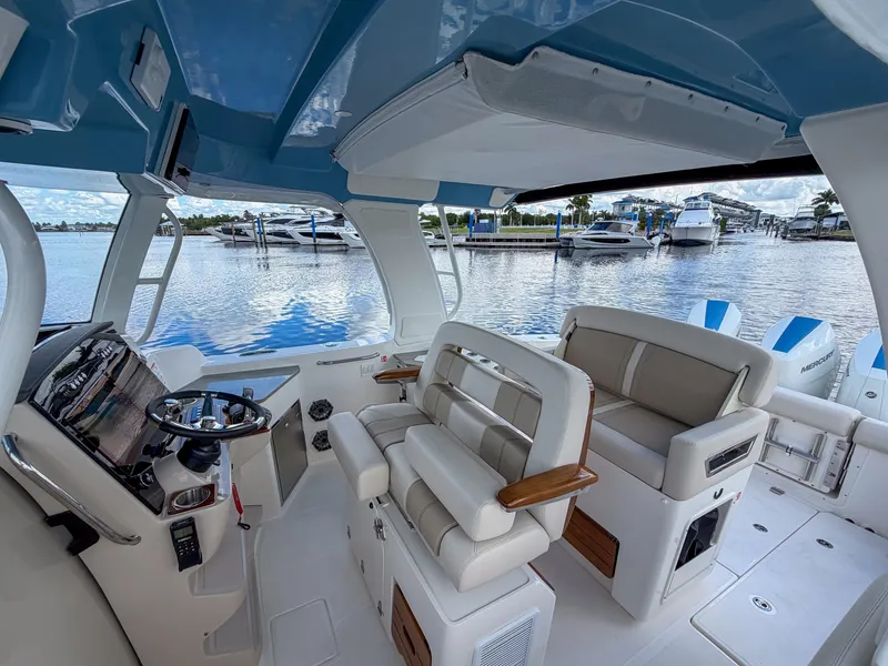 Slide: The Image of The image shows the cockpit of a 2027 Boston Whaler 350 Realm with luxurious seating and modern features. - 26