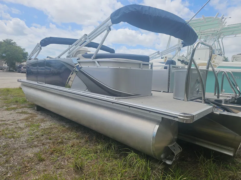 Slide: The Image of 2026 Avalon LSZ 2185 Quad Lounger pontoon boat parked on grass. - 22