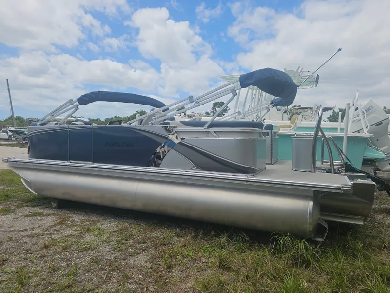 Slide: The Image of 2026 Avalon LSZ 2185 Quad Lounger pontoon boat on grass. - 23