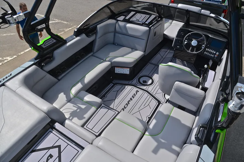 Slide: The Image of 2024 Moomba Mondo boat interior with spacious seating and modern dashboard design. - 19