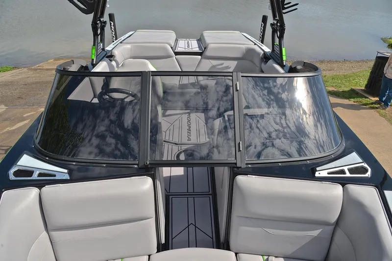 Slide: The Image of 2024 Moomba Mondo boat interior with sleek seating and modern design by the water. - 20