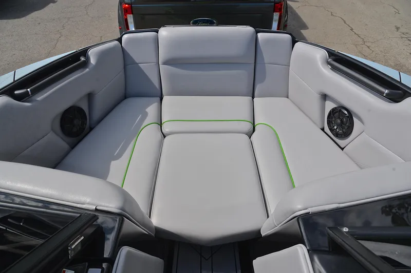 Slide: The Image of 2024 Moomba Mondo boat interior with gray seating and green accents. - 21