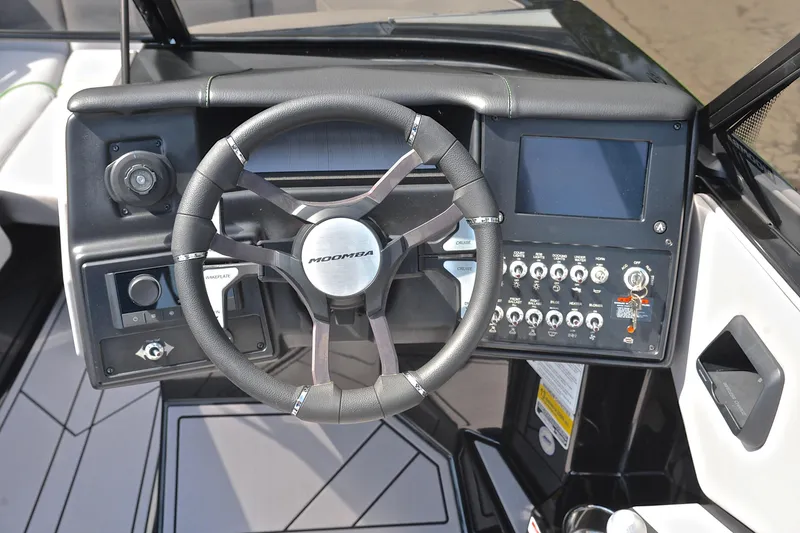 Slide: The Image of 2024 Moomba Mondo boat dashboard with steering wheel and control panel. - 26