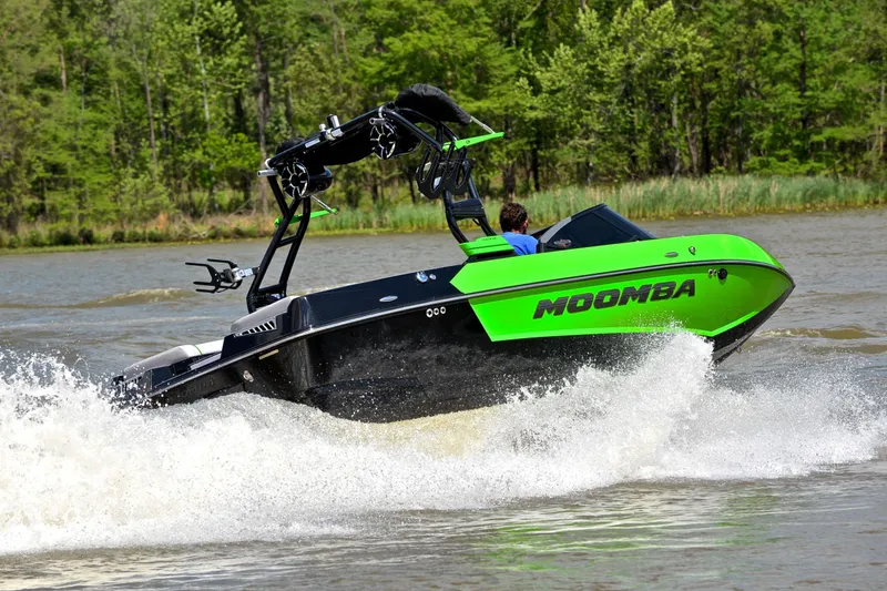 Slide: The Image of 2024 Moomba Mondo boat cruising on a lake, showcasing vibrant green design and powerful performance. - 5