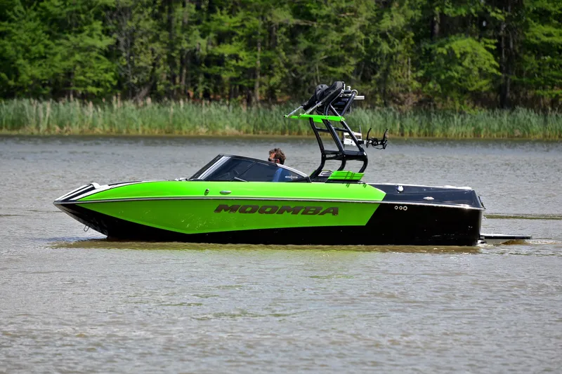Slide: The Image of 2024 Moomba Mondo boat in vibrant green on a calm lake. - 6