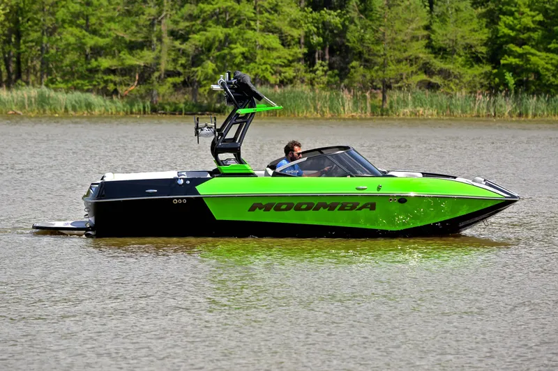 Slide: The Image of 2024 Moomba Mondo boat in vibrant green on a calm lake. - 7