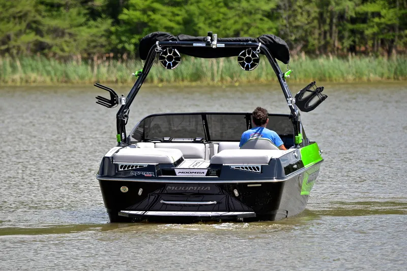 Slide: The Image of 2024 Moomba Mondo boat cruising on a lake with lush greenery in the background. - 8