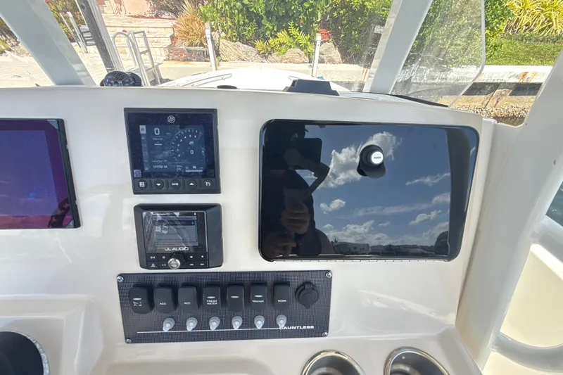 Slide: The Image of Control panel of 2023 Boston Whaler 220 Dauntless boat with navigation and audio systems. - 10