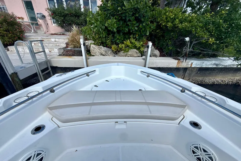 Slide: The Image of 2023 Boston Whaler 220 Dauntless boat interior with seating and cup holders. - 16