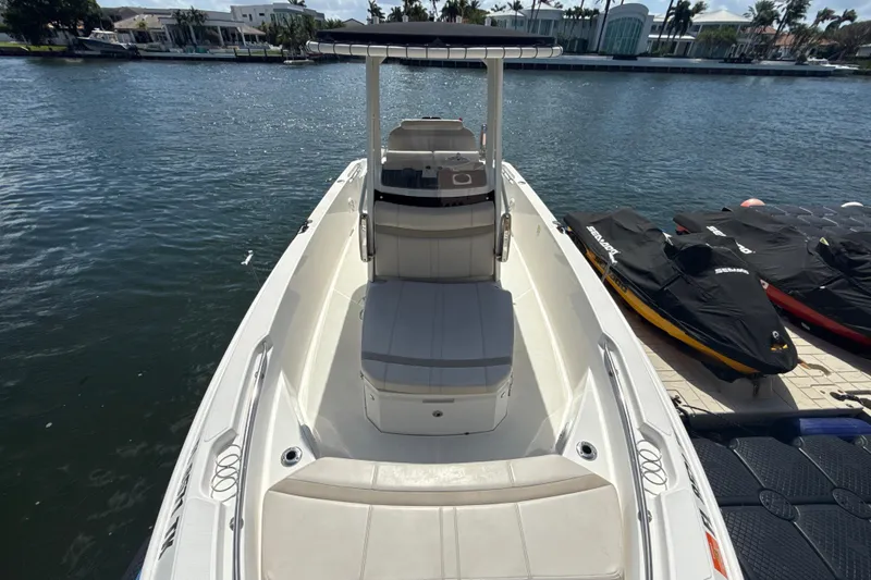 Slide: The Image of 2023 Boston Whaler 220 Dauntless boat docked by the waterfront. - 19