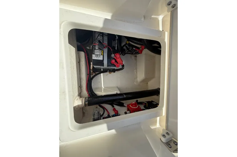 Slide: The Image of 2023 Boston Whaler 220 Dauntless battery compartment with wiring and components. - 23